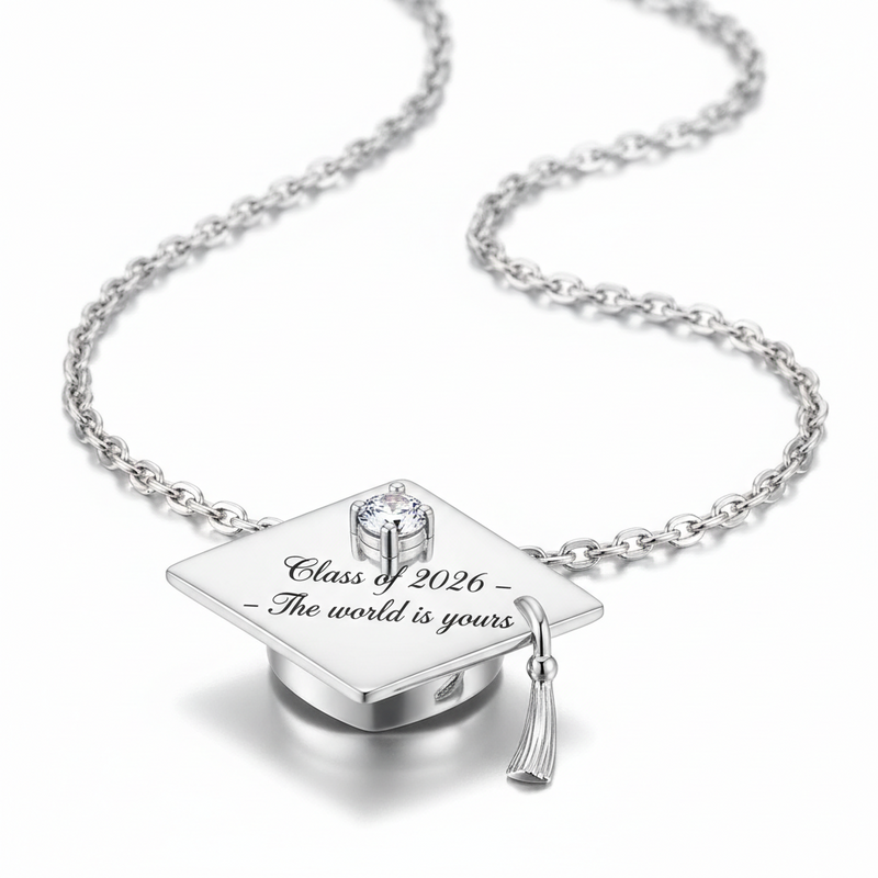 Silver graduation cap pendant necklace with 'Class of 2026 - The world is yours' text on a white background